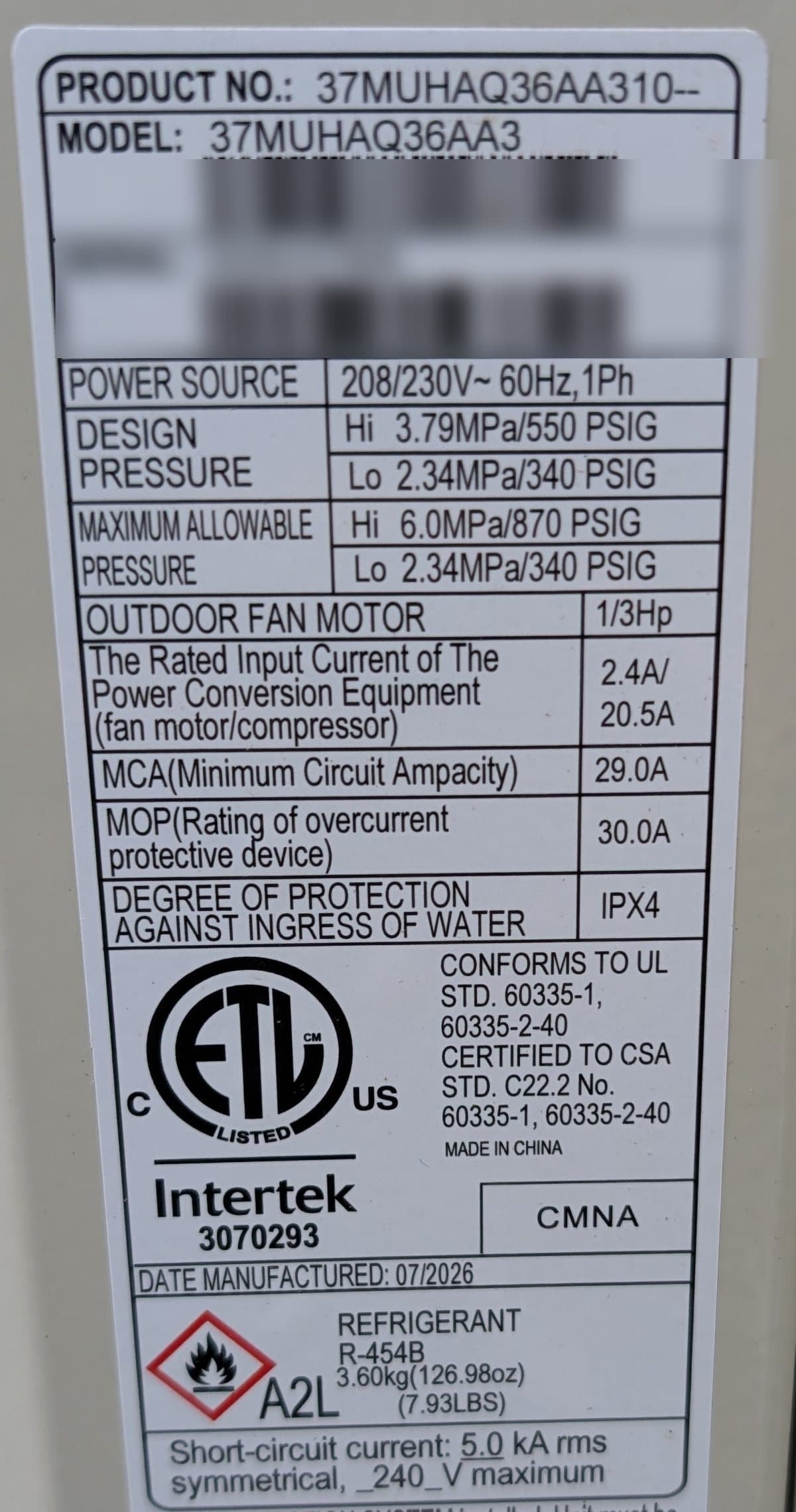 Carrier heat pump outdoor unit rating plate showing refrigerant R-454B, A2L pictogram and a July 2026 manufacture date