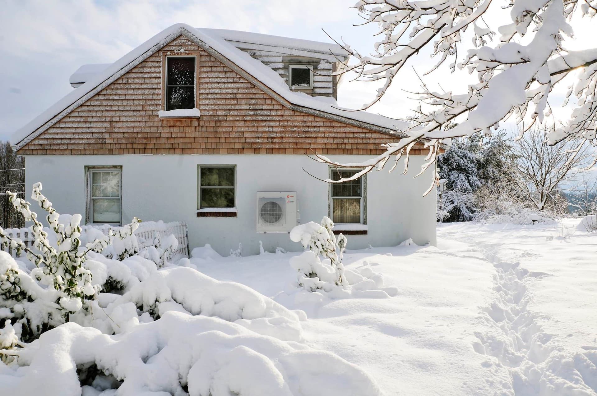 Mitsubishi HyperHeat H2i outdoor unit in deep snow