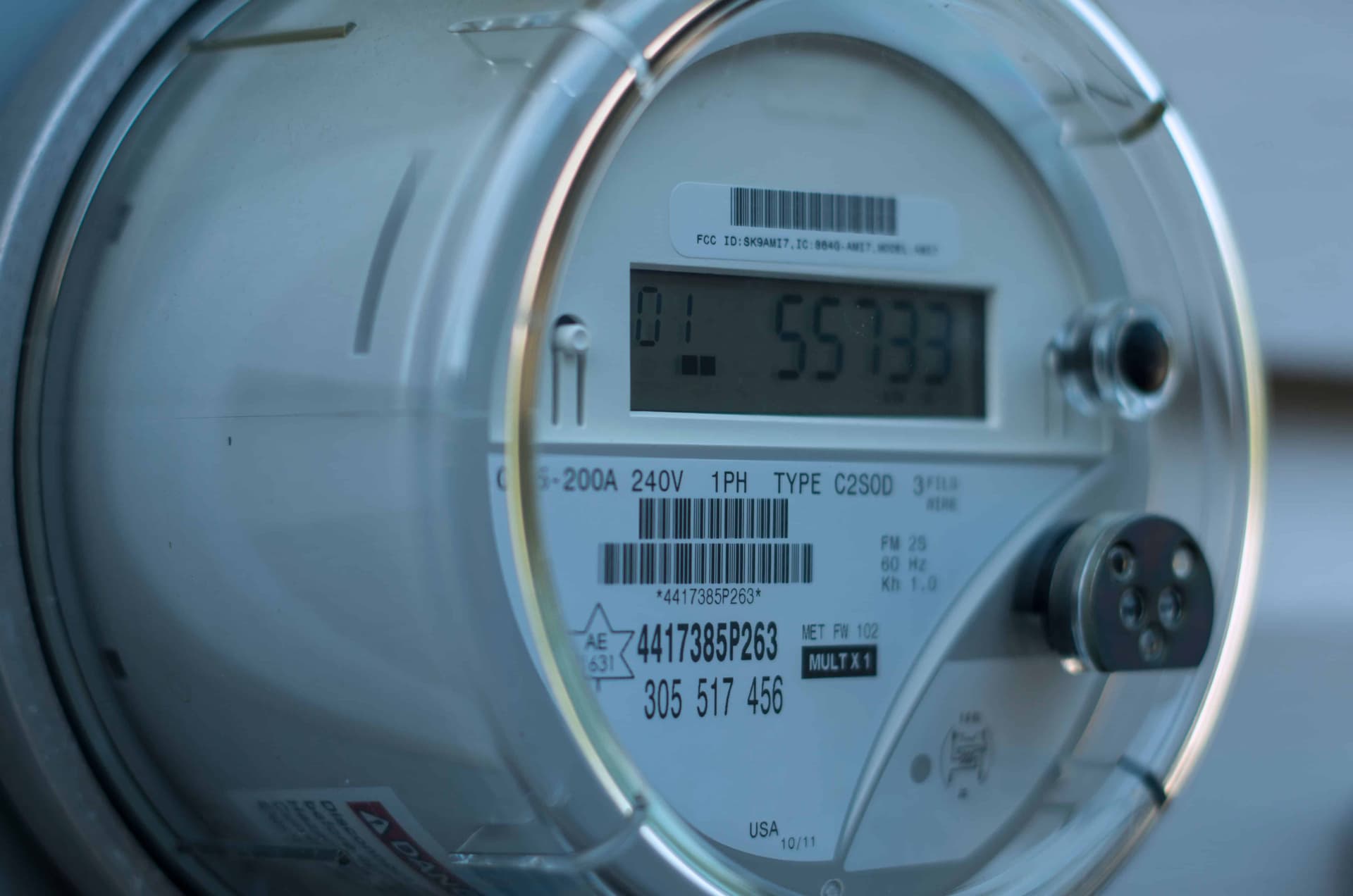 Close-up of a residential 200A 240V smart electric meter face showing the digital kWh display and rating label