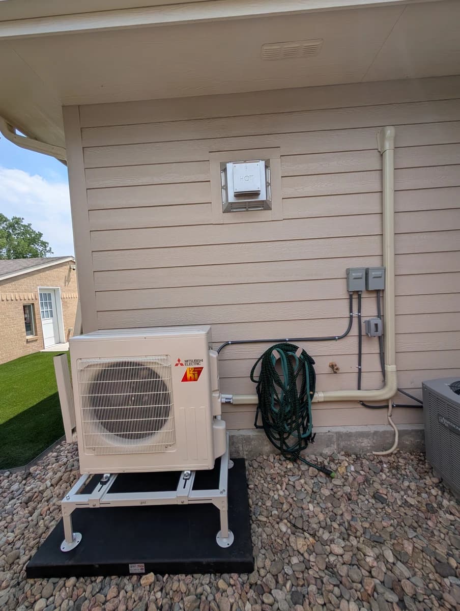 Mini-split outdoor unit on a raised stand at an Edgewater home