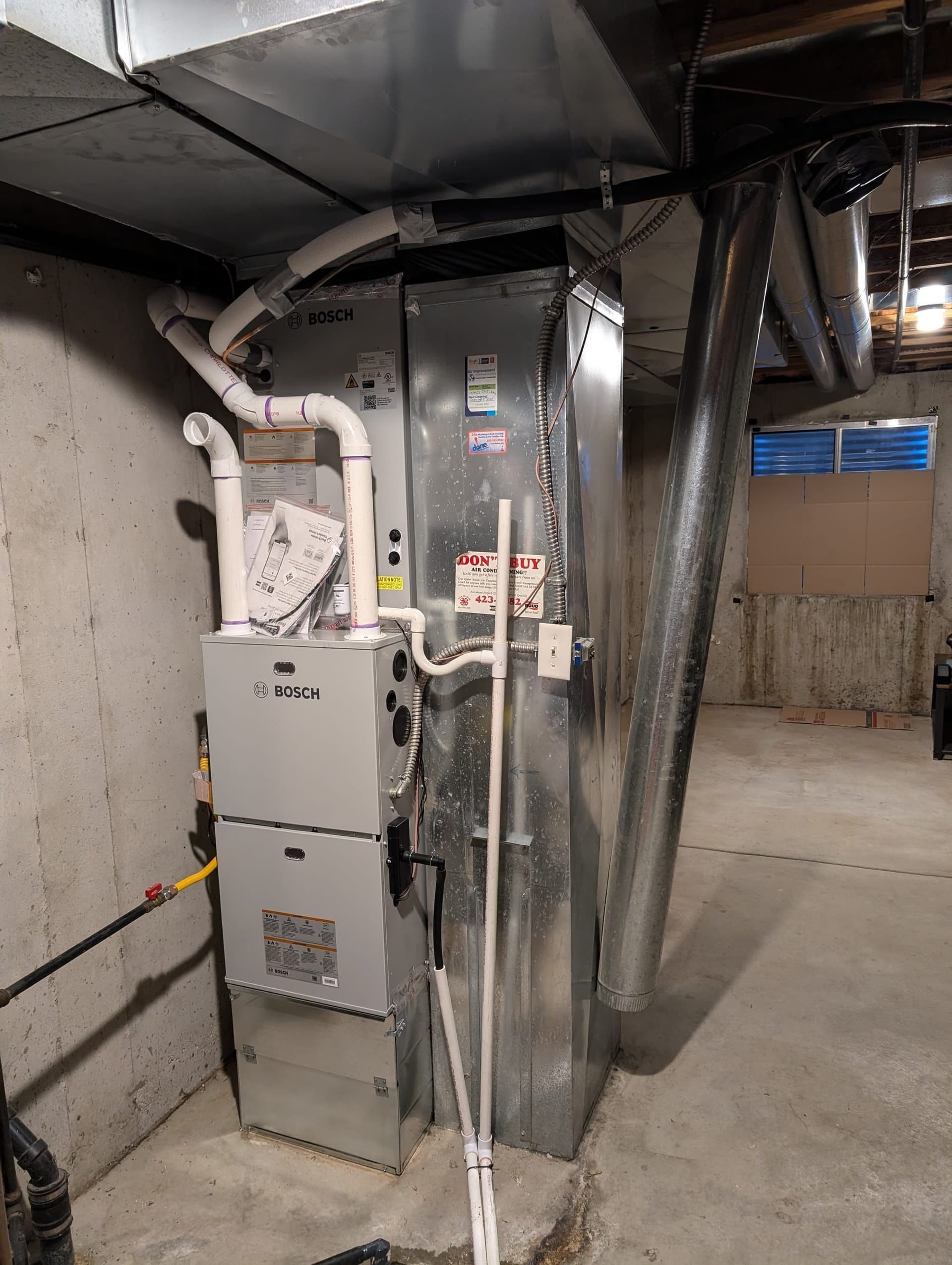 Bosch furnace and air handler with sticker in concrete basement