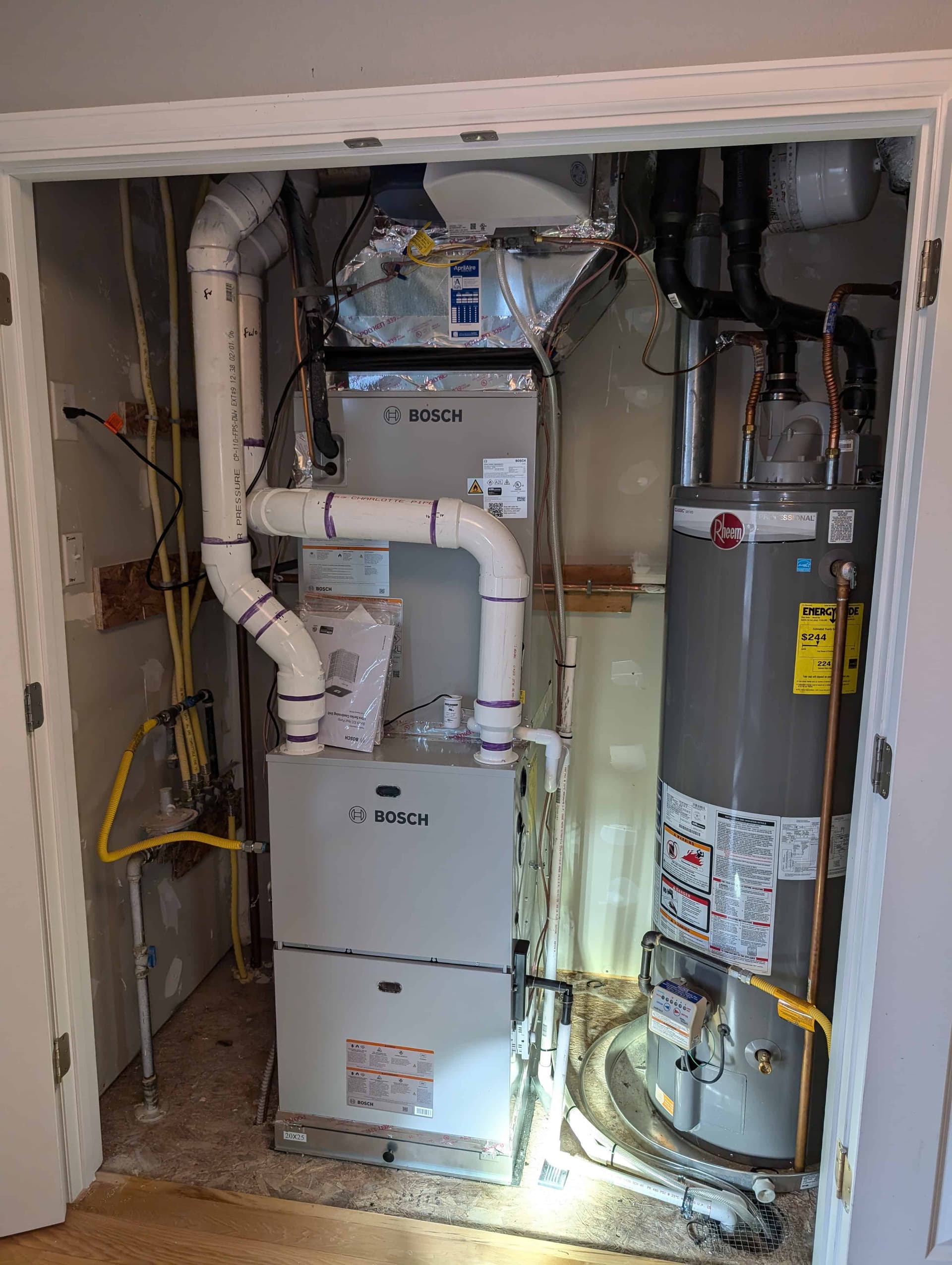 Bosch furnace and air handler with Rheem water heater in utility room