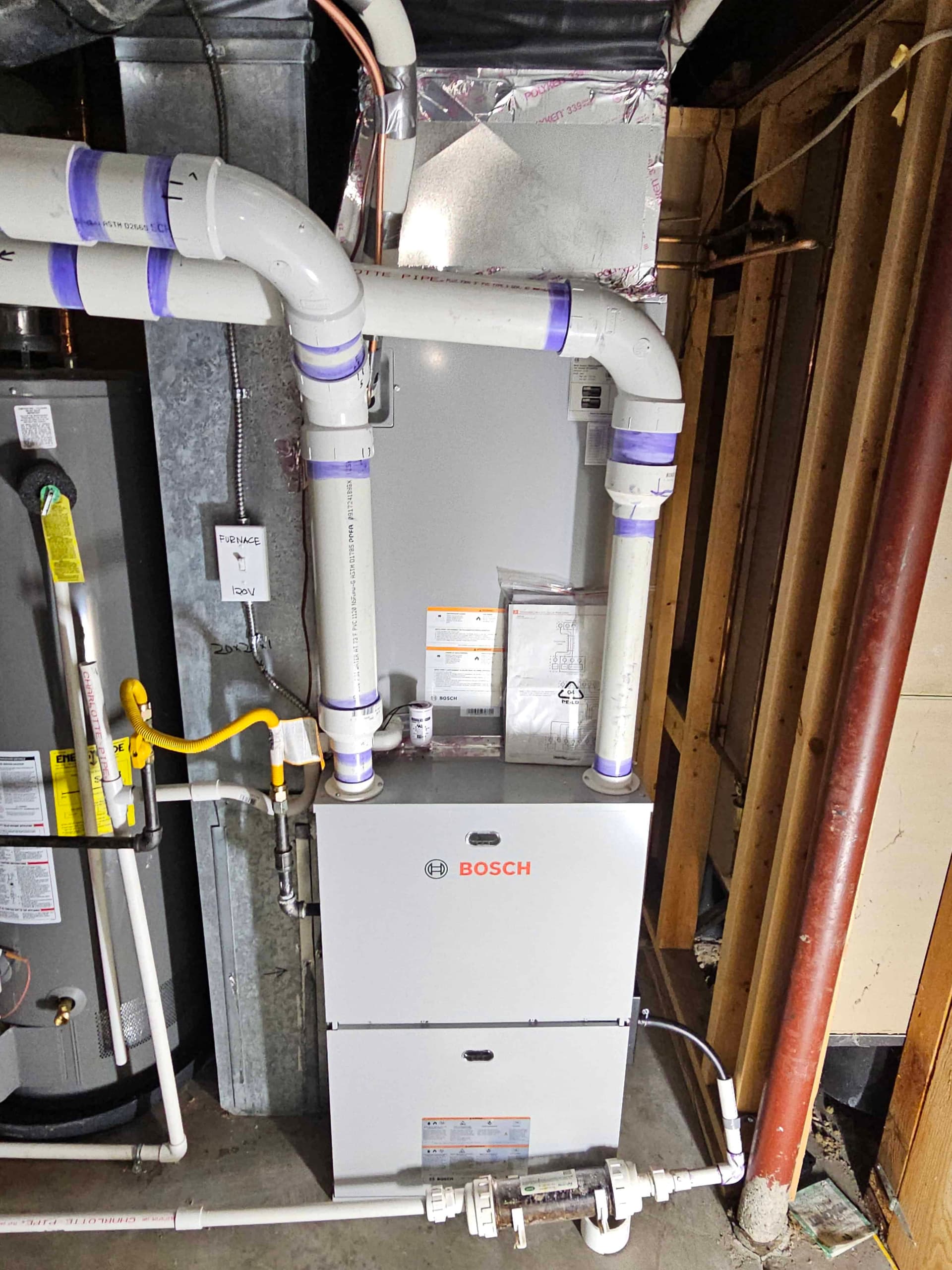 Bosch dual fuel furnace with purple taped pipes and water heater