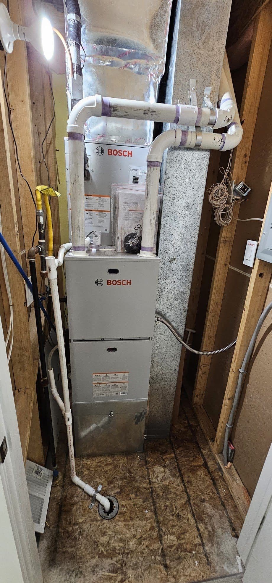 Bosch furnace installation in unfinished basement with OSB flooring