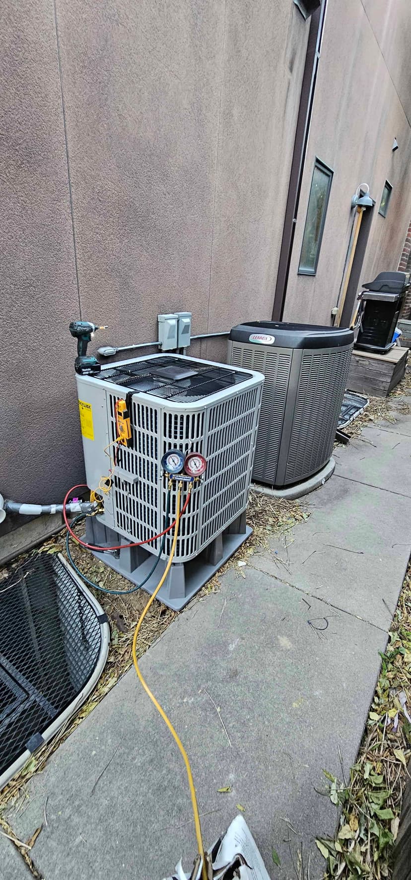 AC condenser with refrigerant gauges during service