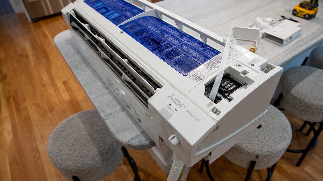 Floor-mount mini-split unit replacing a boiler system