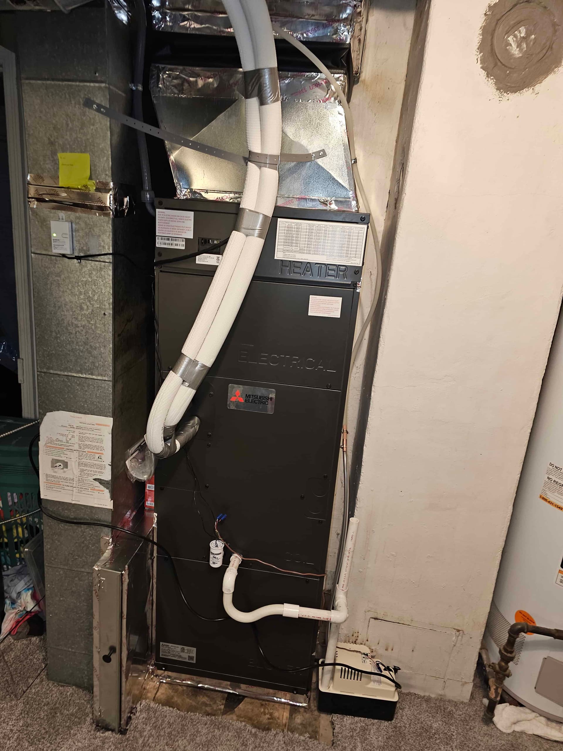 Mitsubishi ducted air handler with electric backup heat installed in a Denver basement