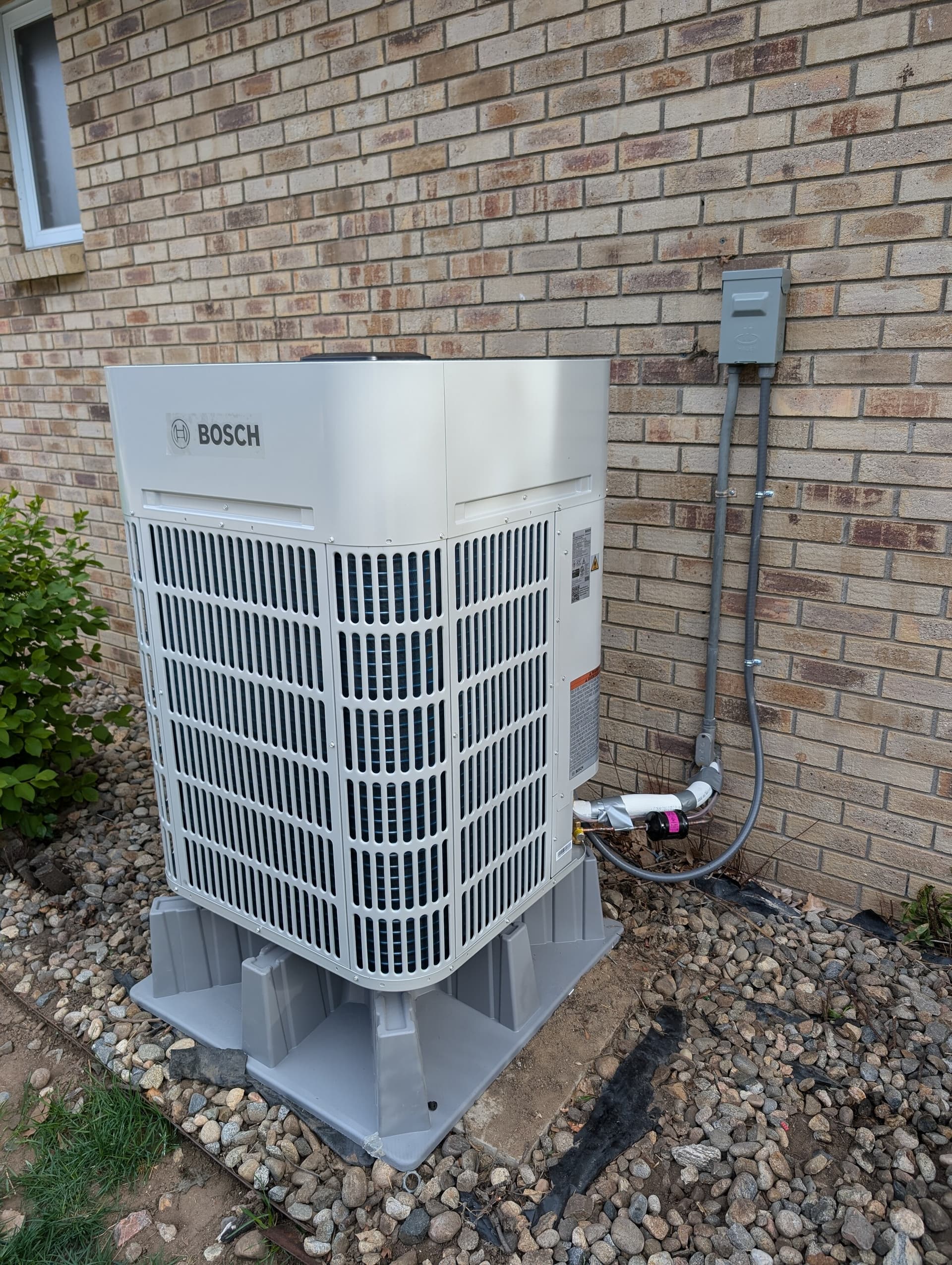 Bosch heat pump on a riser pad installed by UniColorado in the Denver area, April 2026